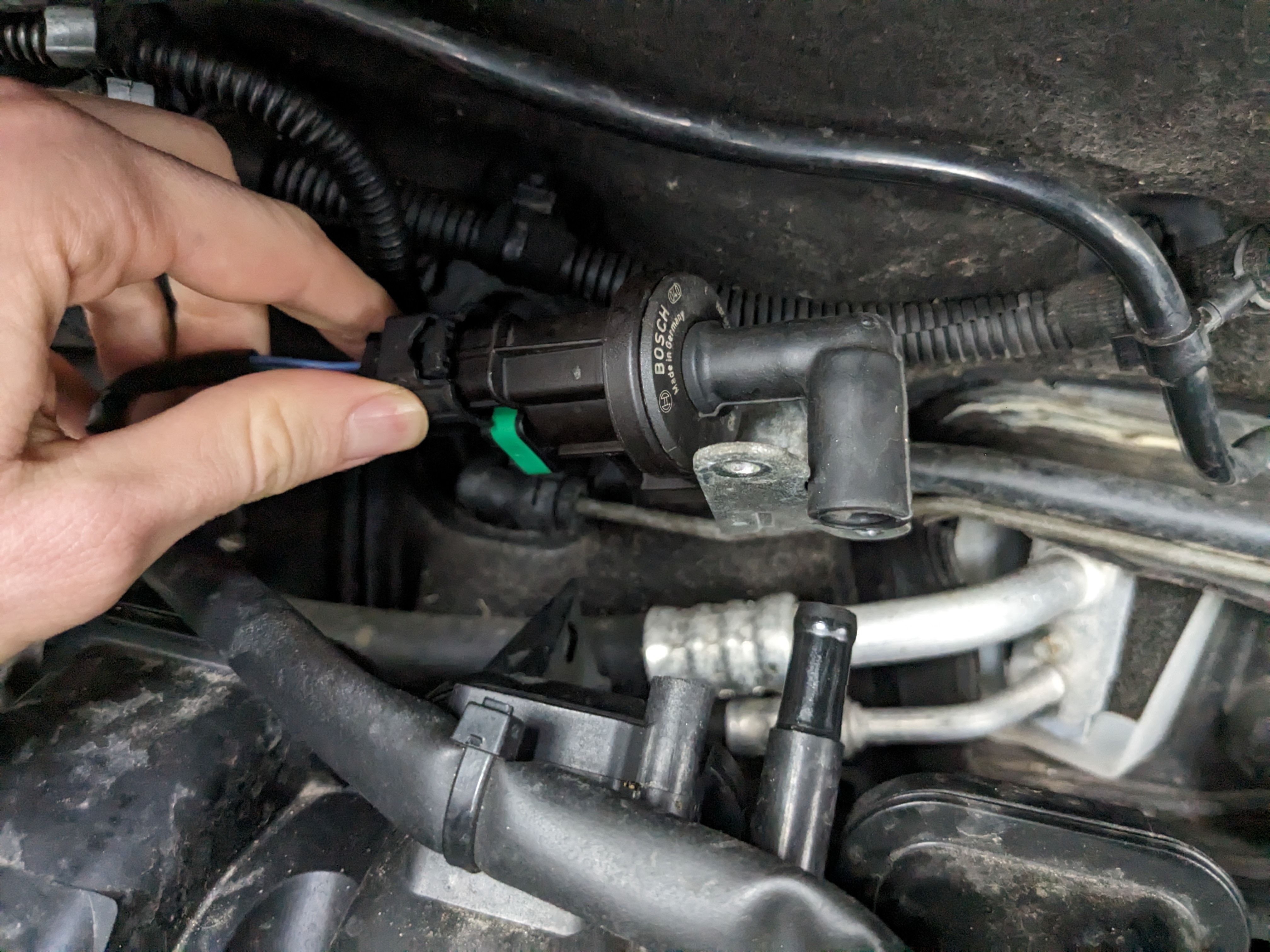 Bracket removed from purge valve allowing valve to be pulled free